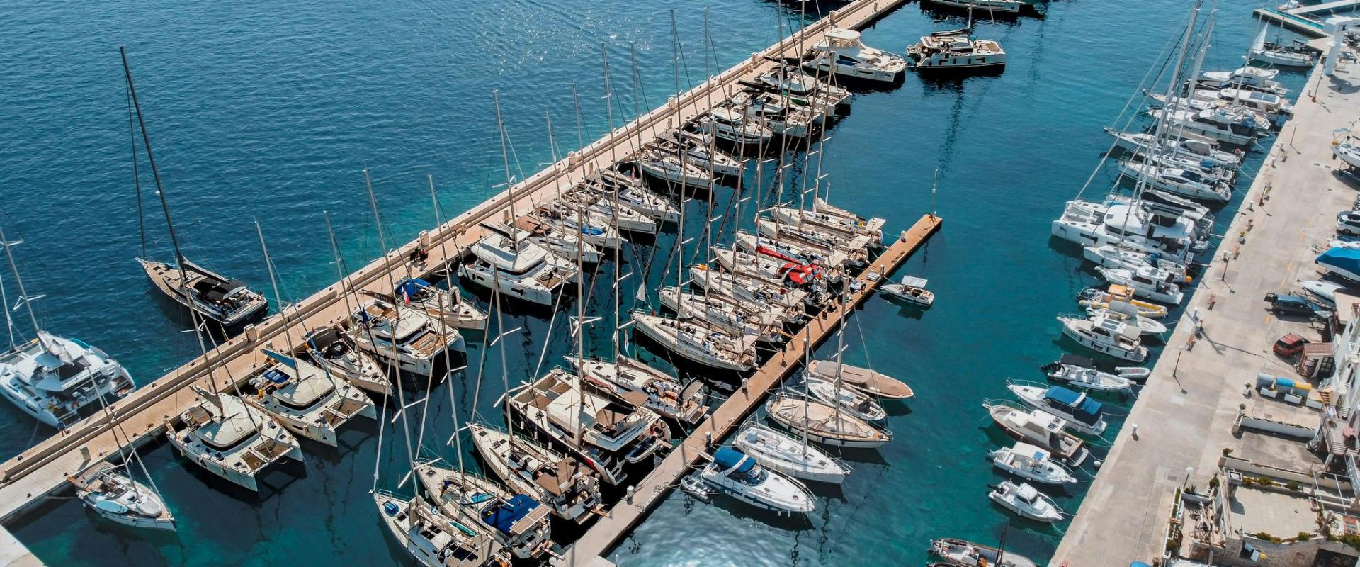 Stunning aerial view of a Croatian marina filled with yachts and sailboats moored along the docks.