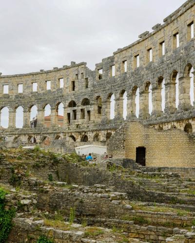 Explore the historic Roman amphitheater ruins in Pula, a major tourist attraction in Croatia.