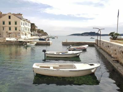 Peaceful harbor scene with docked boats and historic architecture in Hvar, Croatia.