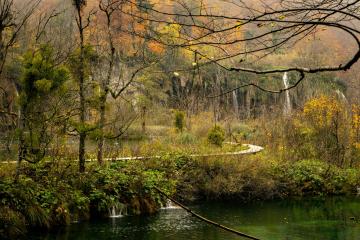 Scenic view of autumn foliage and waterfalls in Plitvice Lakes National Park, Croatia.