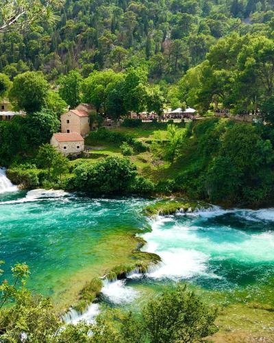 Picturesque view of waterfalls and lush greenery in Krka National Park, Croatia.