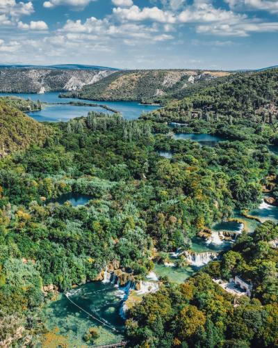 A breathtaking aerial view of lush greenery and waterfalls in Krka National Park, Croatia.