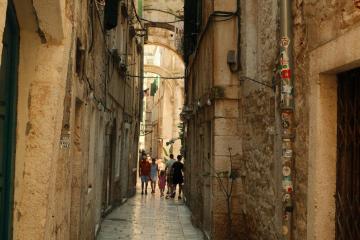 Explore the historic narrow streets of Split, Croatia, capturing its medieval charm and vibrant ambiance.