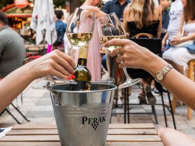 a couple of people that are holding wine glasses
