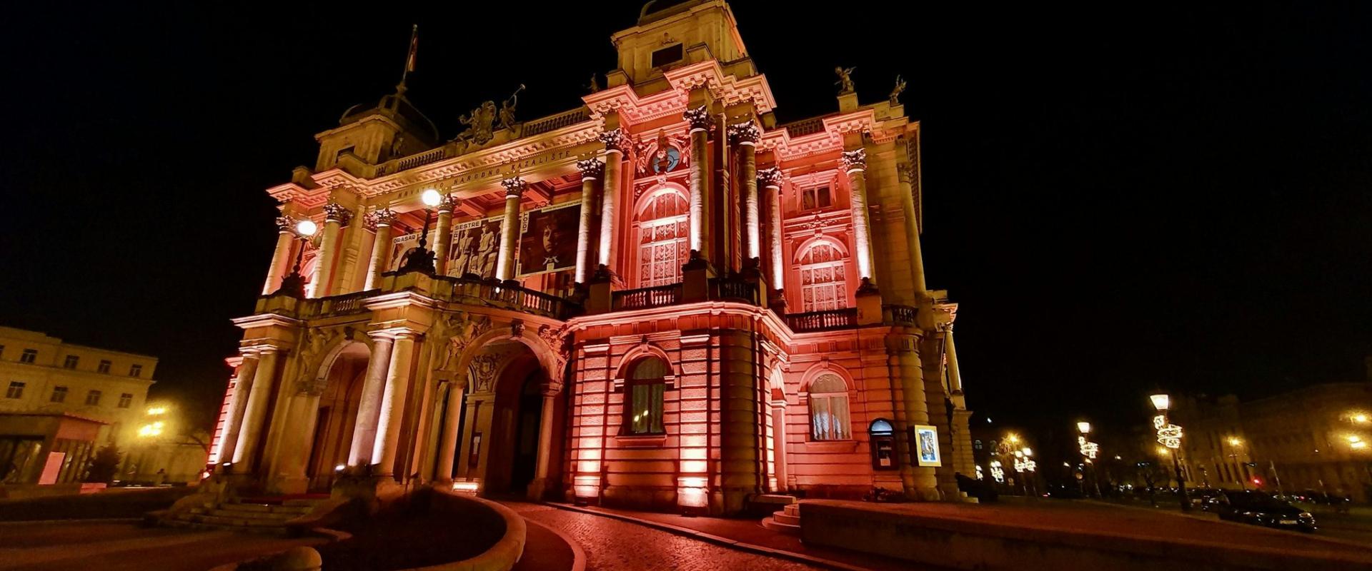 a large building lit up with red lights